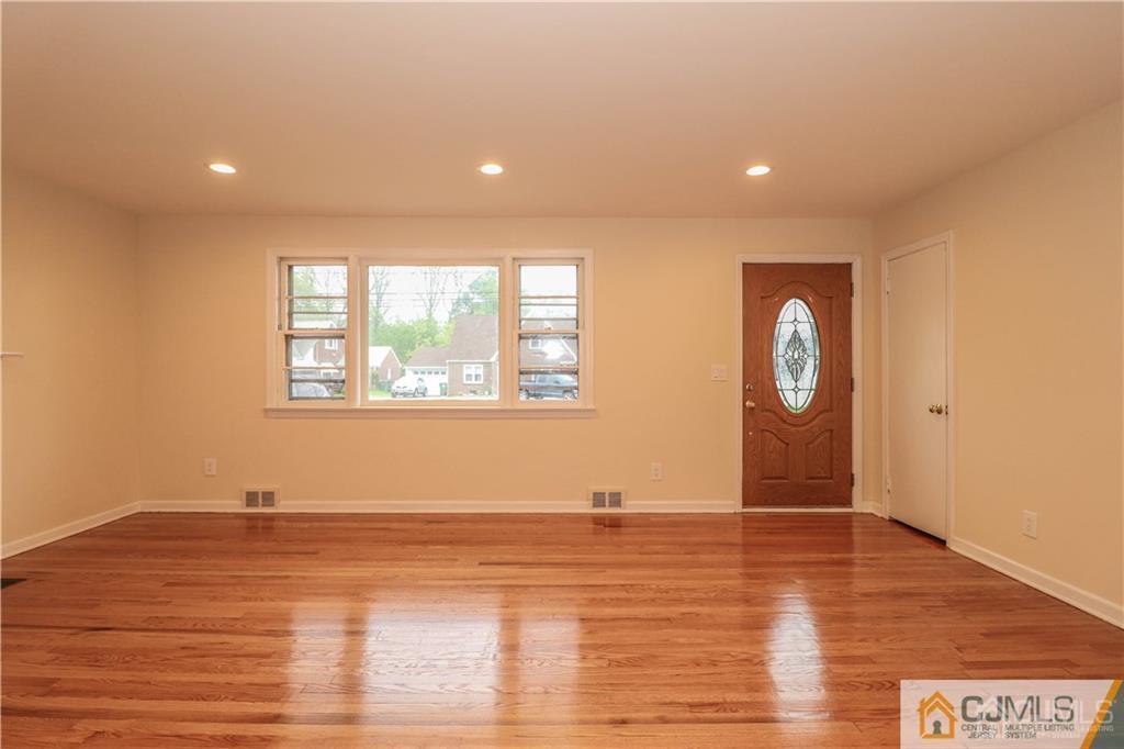 20 Old Post Road Edison, NJ 08817 - Photo 9 of 25 an empty room with wooden floor and windows