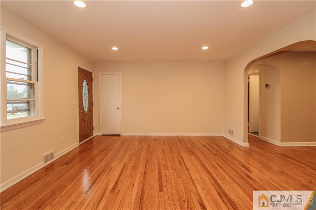 20 Old Post Road Edison, NJ 08817 - Photo 10 of 25 a view of an empty room with wooden floor and a window