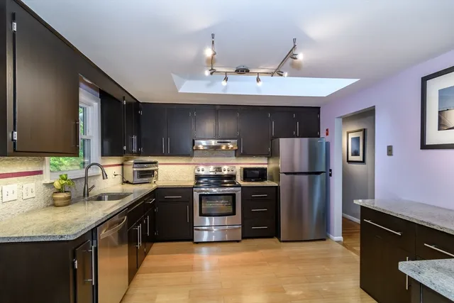 a kitchen with a sink and stainless steel appliances