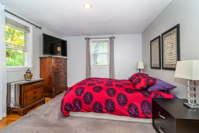 a bedroom with a bed and flat screen tv