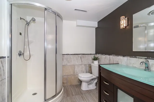 a bathroom with a sink toilet and shower