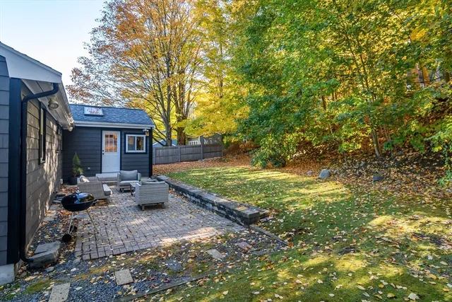 a front view of a house with a garden and sitting area