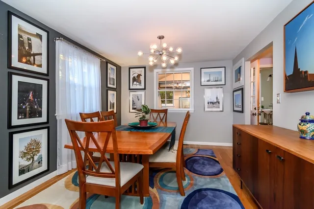a view of a dining room with furniture and chandelier