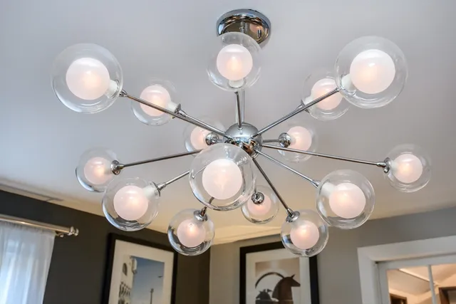 a view of a mirror with a fan and wooden floor