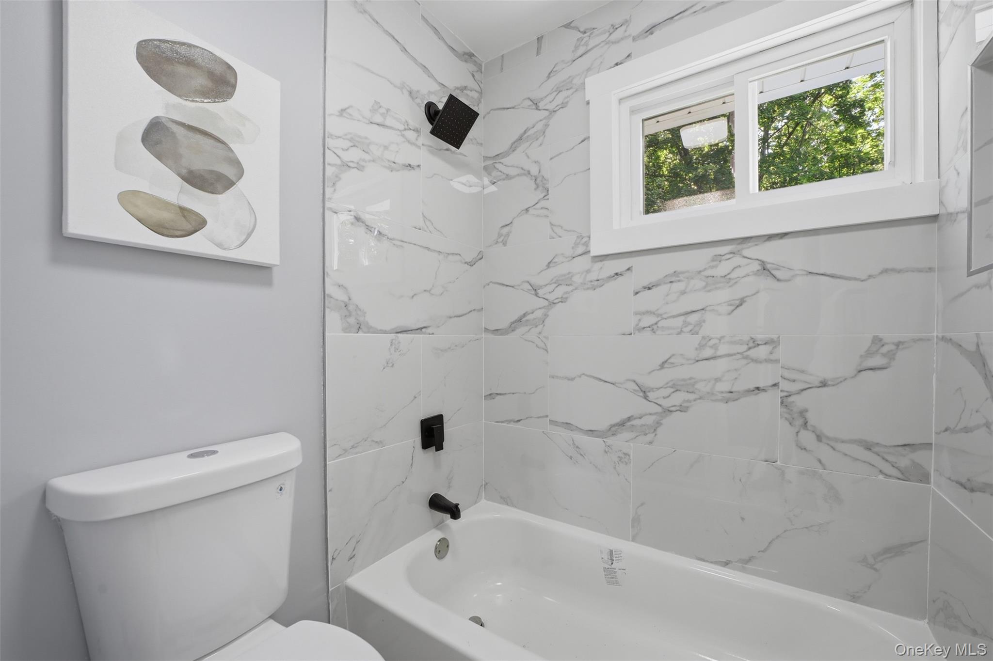 24 Fuller Road Ossining, NY 10562 - Photo 23 of 48 a bath tub sitting next to a white toilet and a shower