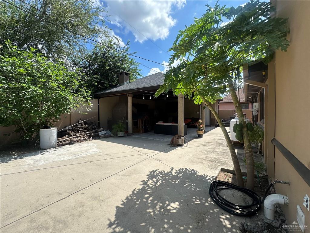 8200 Mars Lane Mission, TX 78574 - Photo 27 of 33 a backyard of a house with table and chairs plants