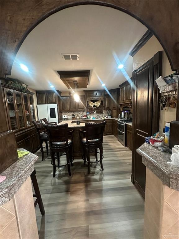 8200 Mars Lane Mission, TX 78574 - Photo 7 of 33 a kitchen with stainless steel appliances kitchen island granite countertop a table chairs and a refrigerator