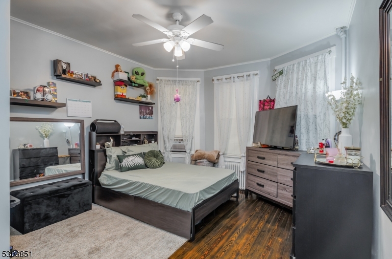 22 Sears Place Clifton, NJ 07011 - Photo 2 of 8 a living room with furniture and a flat screen tv