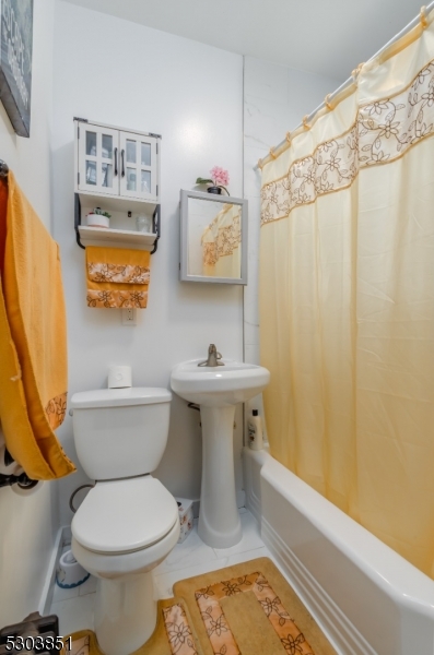 22 Sears Place Clifton, NJ 07011 - Photo 3 of 8 a bathroom with a sink a toilet and shower