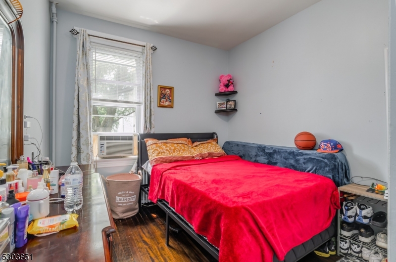 22 Sears Place Clifton, NJ 07011 - Photo 5 of 8 a bedroom with a bed and wooden floor