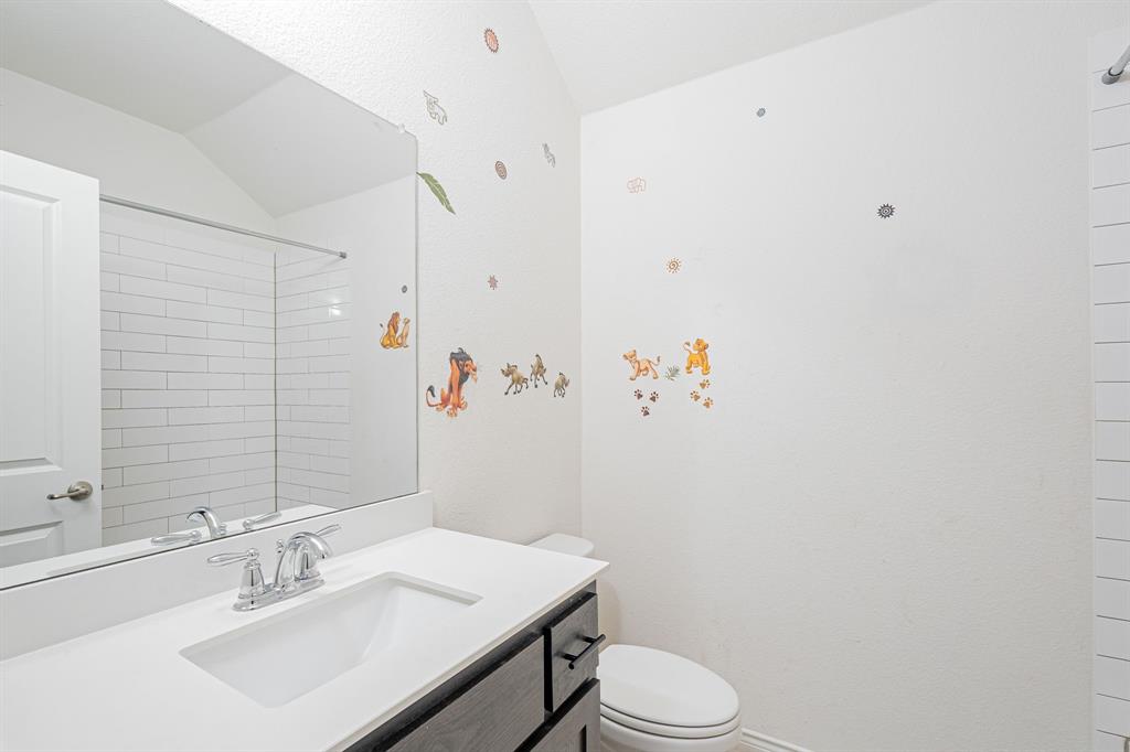 1500 Elizabeth Street Anna, TX 75409 - Photo 13 of 25 a bathroom with a sink a toilet and mirror