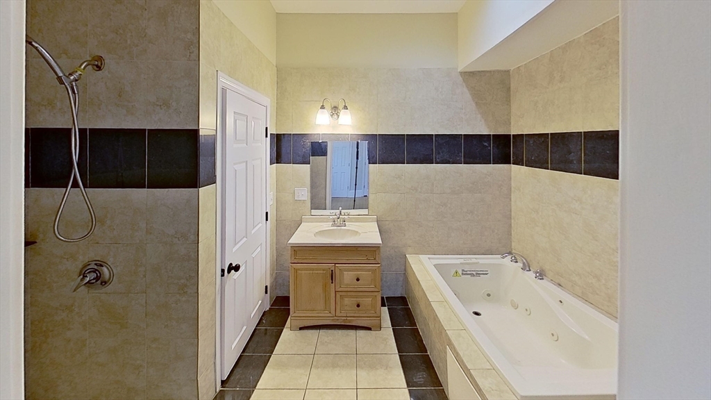 9 Landor Road, Unit 3 Boston, MA 02126 - Photo 4 of 7 a bathroom with a double vanity sink a mirror and shower