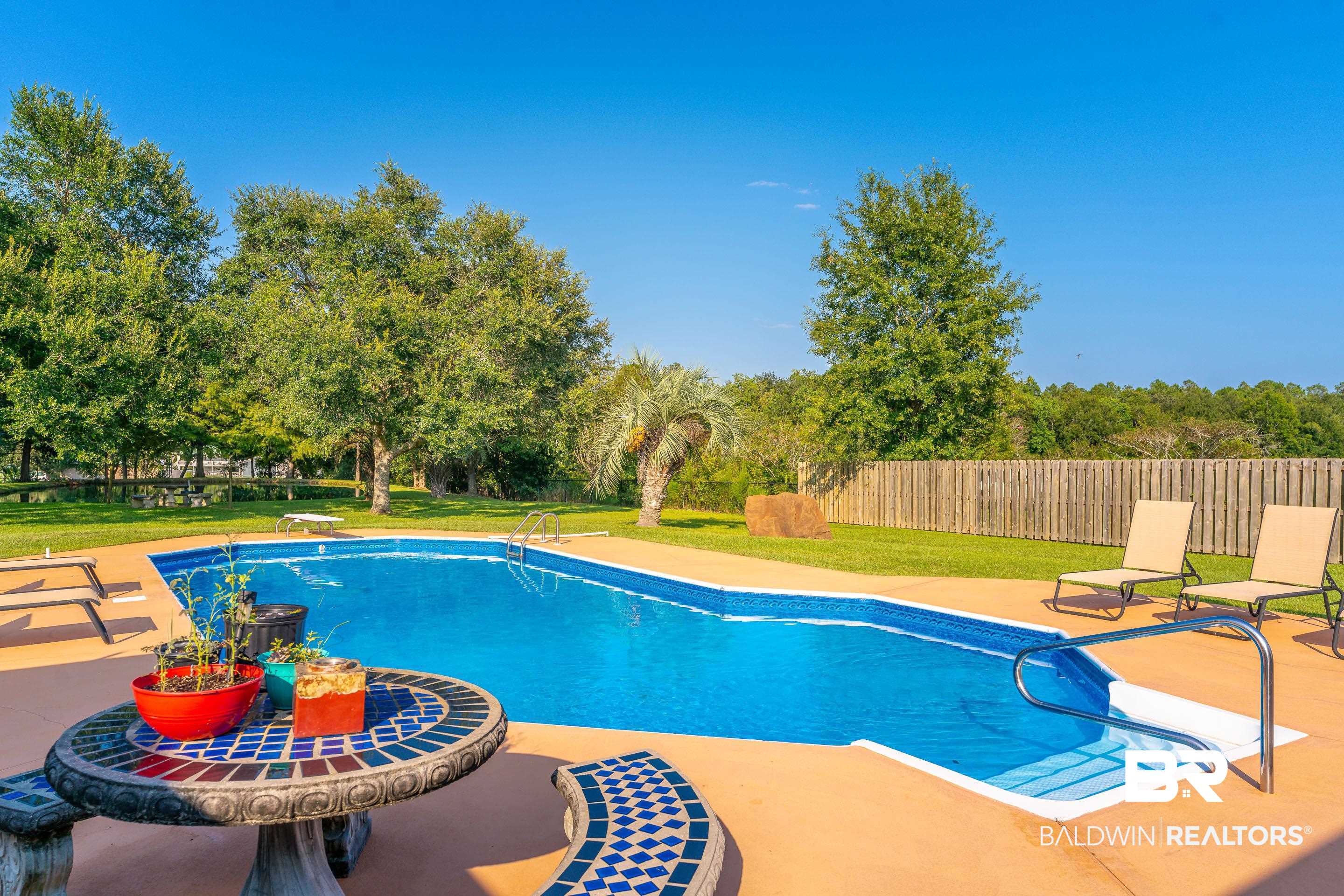 9477 Deerfield Drive Irvington, AL 36544 - Photo 38 of 58 View of swimming pool with a lawn, a diving board, and a patio