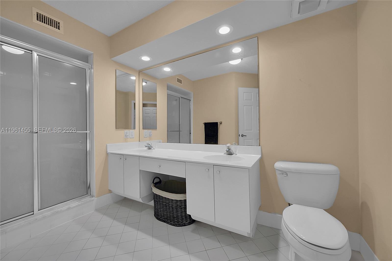 17317 Boca Club Boulevard, Unit 7 Boca Raton, FL 33487 - Photo 27 of 48 a bathroom with a toilet sink and mirror