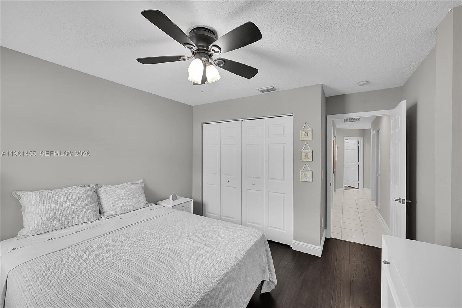 17317 Boca Club Boulevard, Unit 7 Boca Raton, FL 33487 - Photo 33 of 48 a bedroom with a large bed and a chandelier