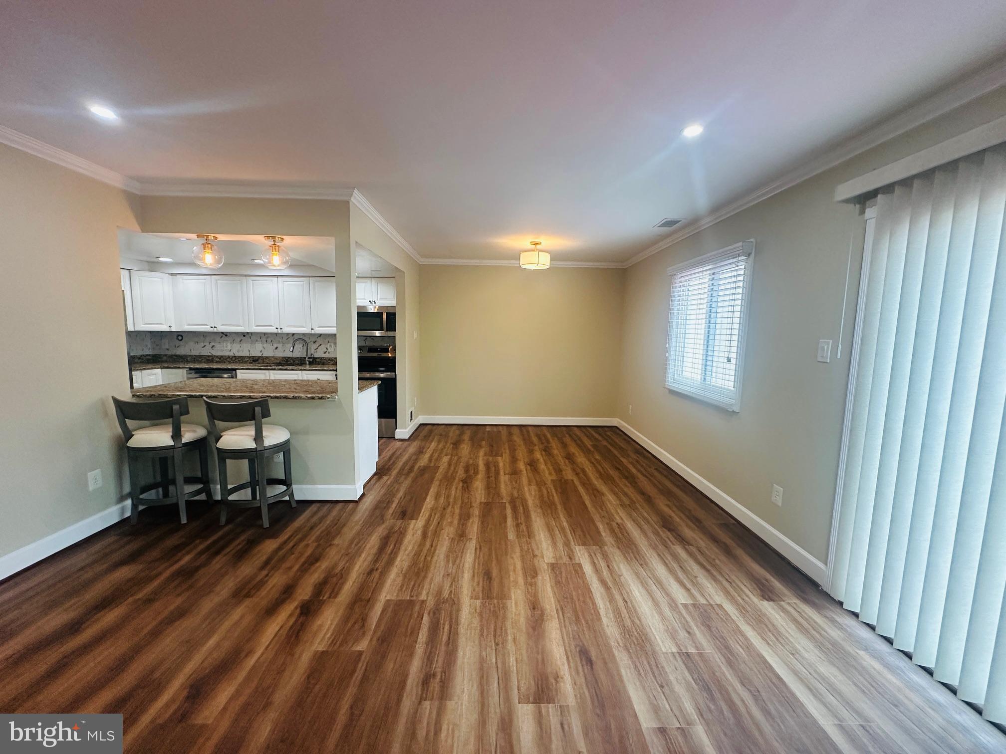 102 Hayloft Circle Sterling, VA 20164 - Photo 11 of 39 wooden floor in an empty room with a window