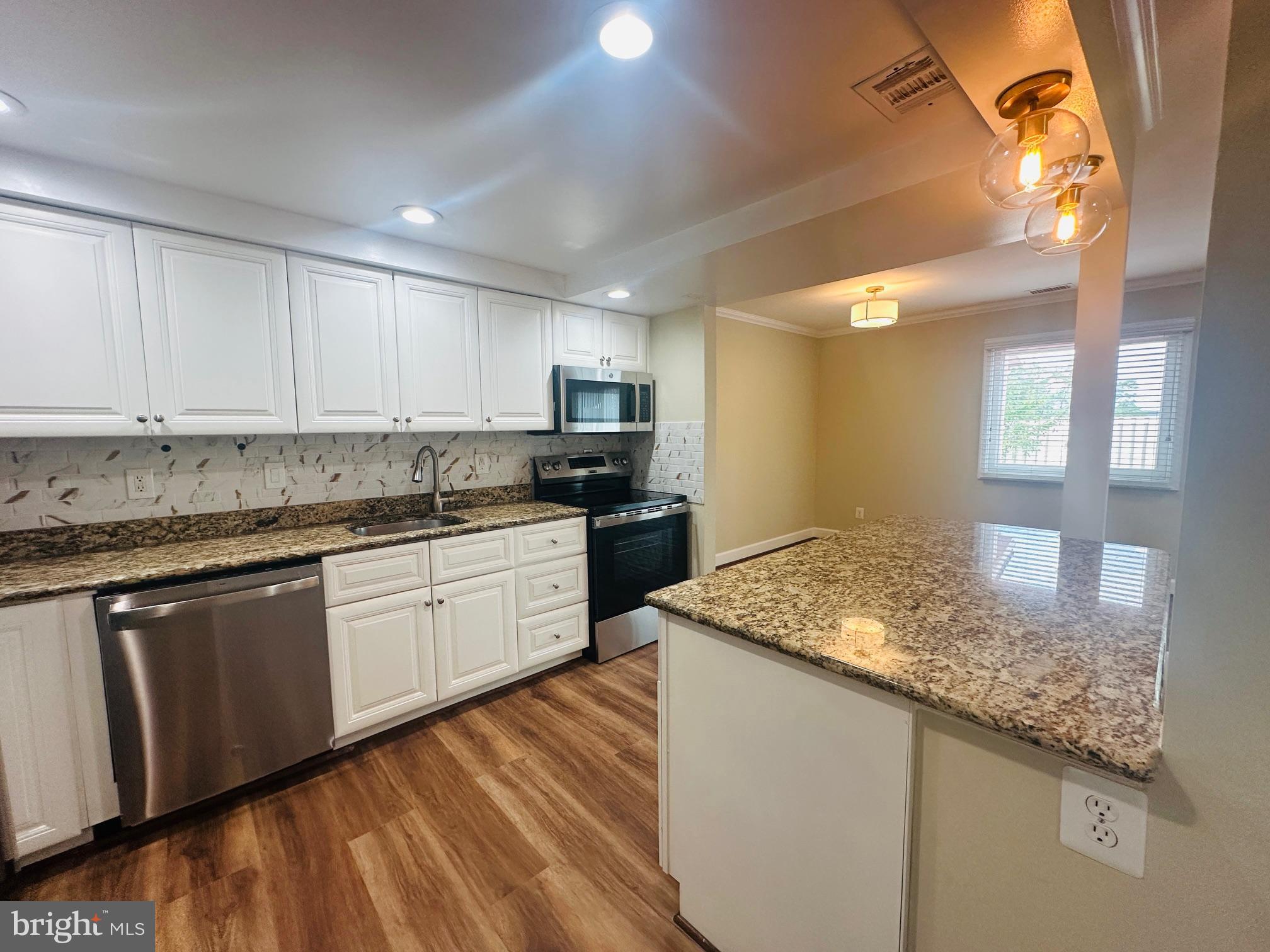102 Hayloft Circle Sterling, VA 20164 - Photo 13 of 39 a kitchen with granite countertop cabinets and window