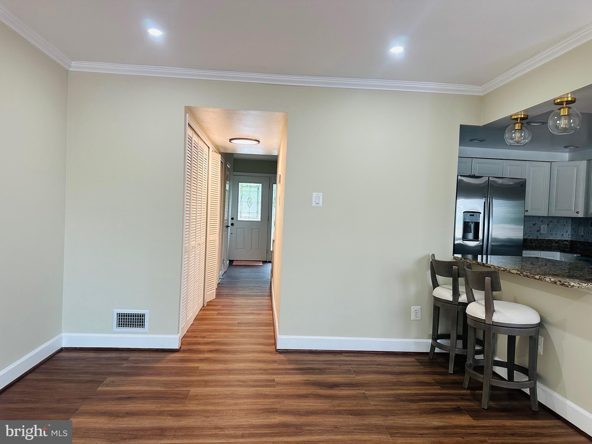 102 Hayloft Circle Sterling, VA 20164 - Photo 14 of 39 a view of a hallway with chairs and wooden floor