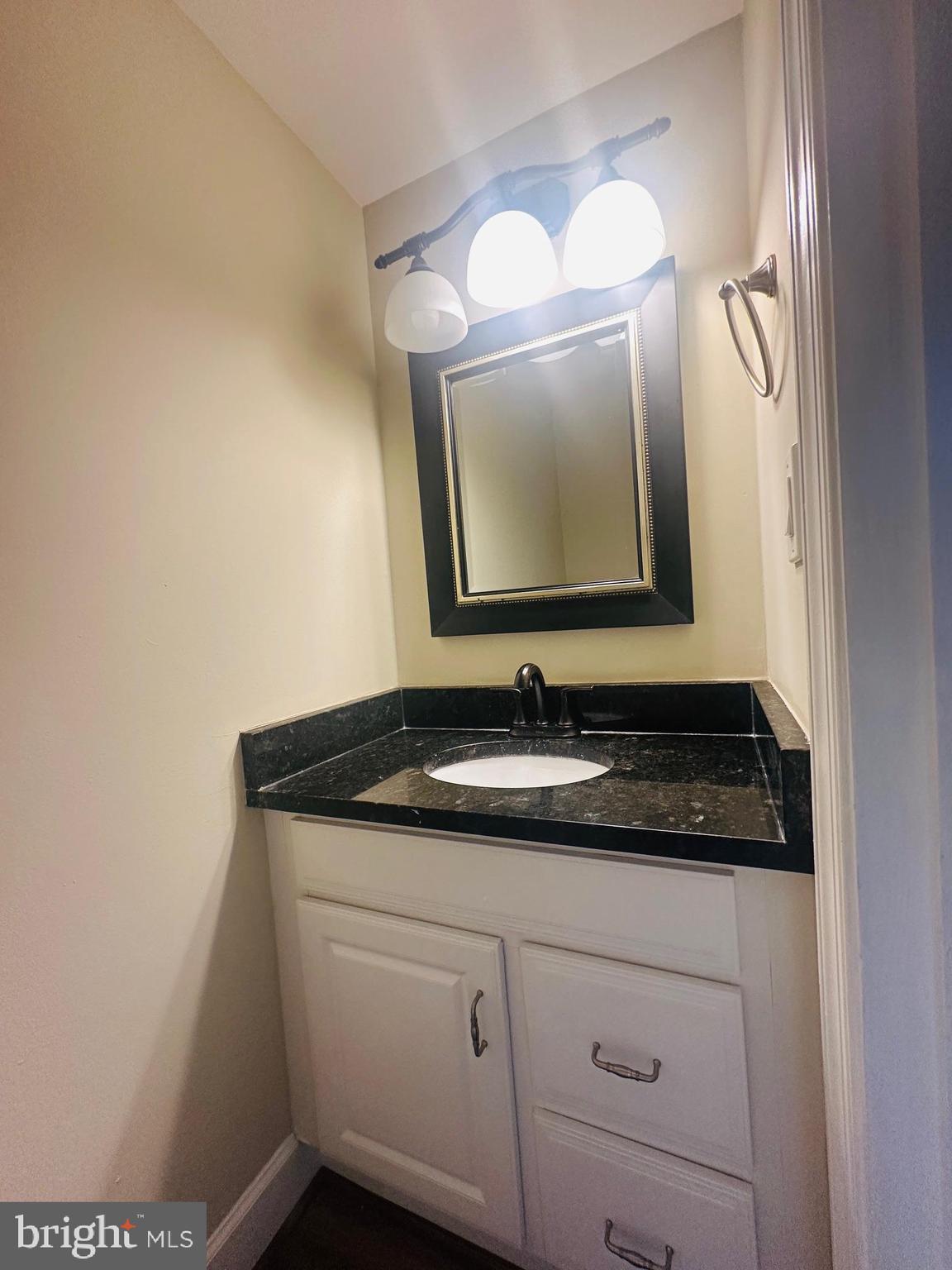 102 Hayloft Circle Sterling, VA 20164 - Photo 16 of 39 a bathroom with a granite countertop sink a mirror and vanity