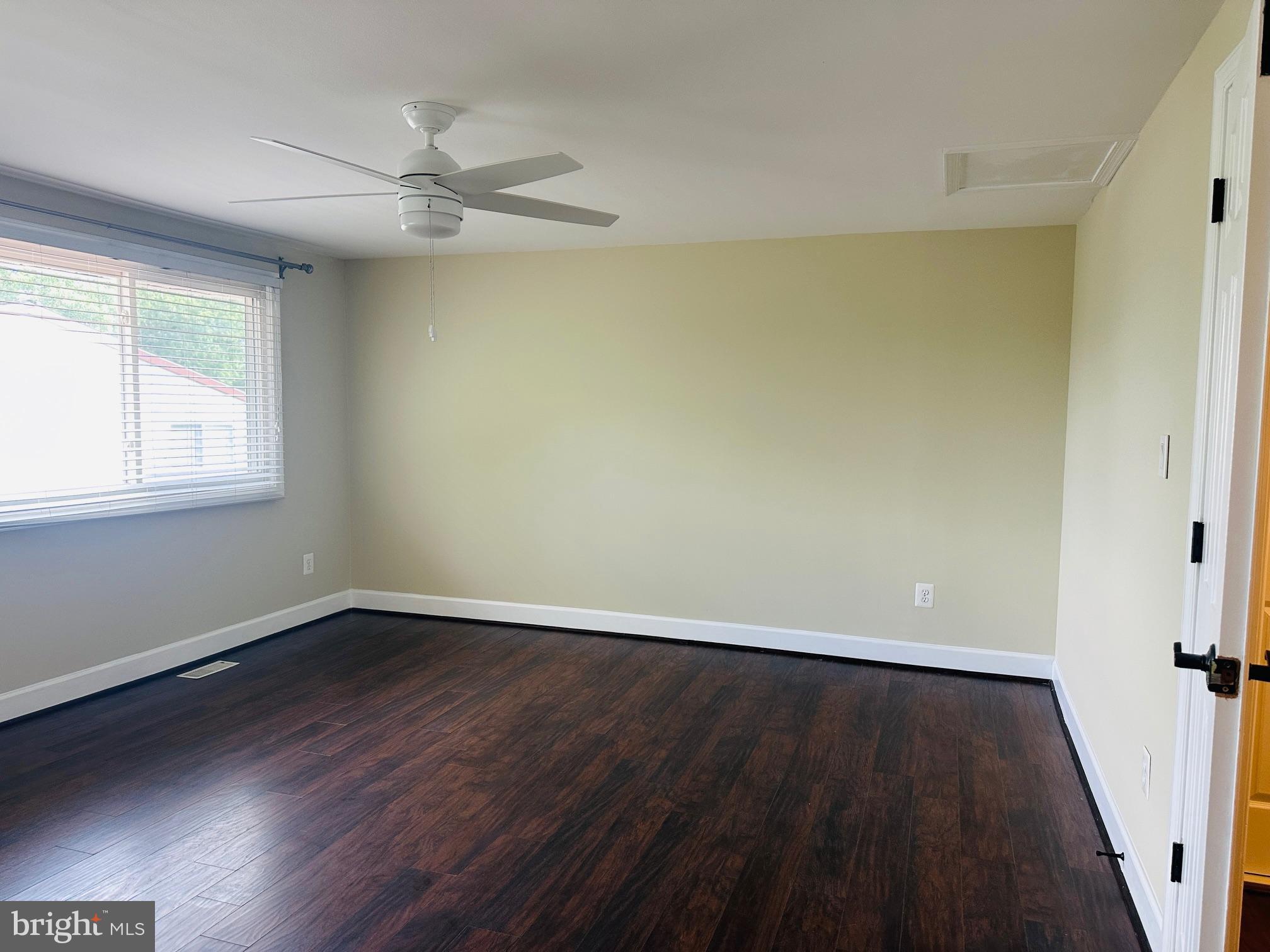 102 Hayloft Circle Sterling, VA 20164 - Photo 20 of 39 a view of an empty room with wooden floor and a window