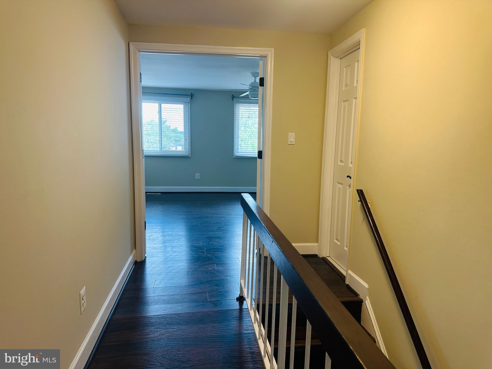 102 Hayloft Circle Sterling, VA 20164 - Photo 28 of 39 a view of a hallway with wooden floor and staircase
