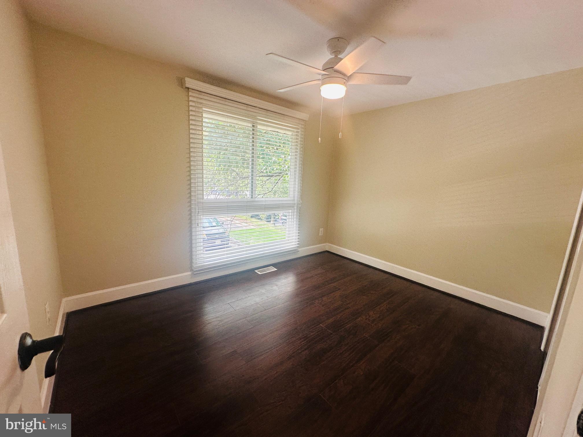 102 Hayloft Circle Sterling, VA 20164 - Photo 31 of 39 a view of an empty room with wooden floor and a window