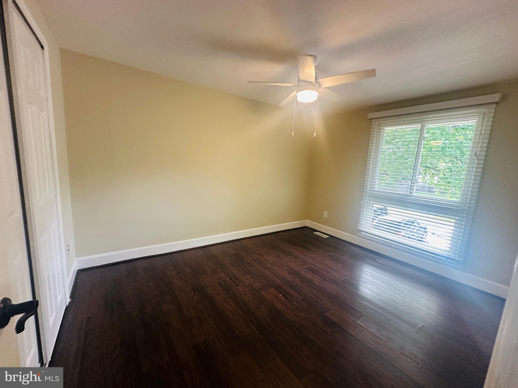 102 Hayloft Circle Sterling, VA 20164 - Photo 32 of 39 an empty room with wooden floor fan and windows