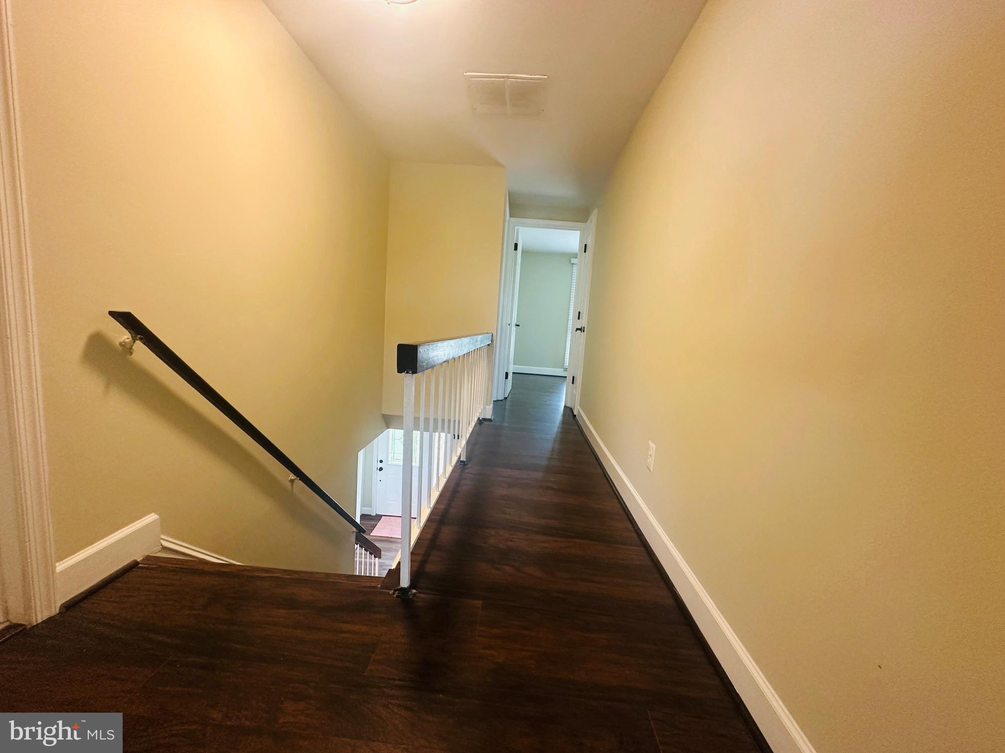 102 Hayloft Circle Sterling, VA 20164 - Photo 36 of 39 a view of a hallway with wooden floor