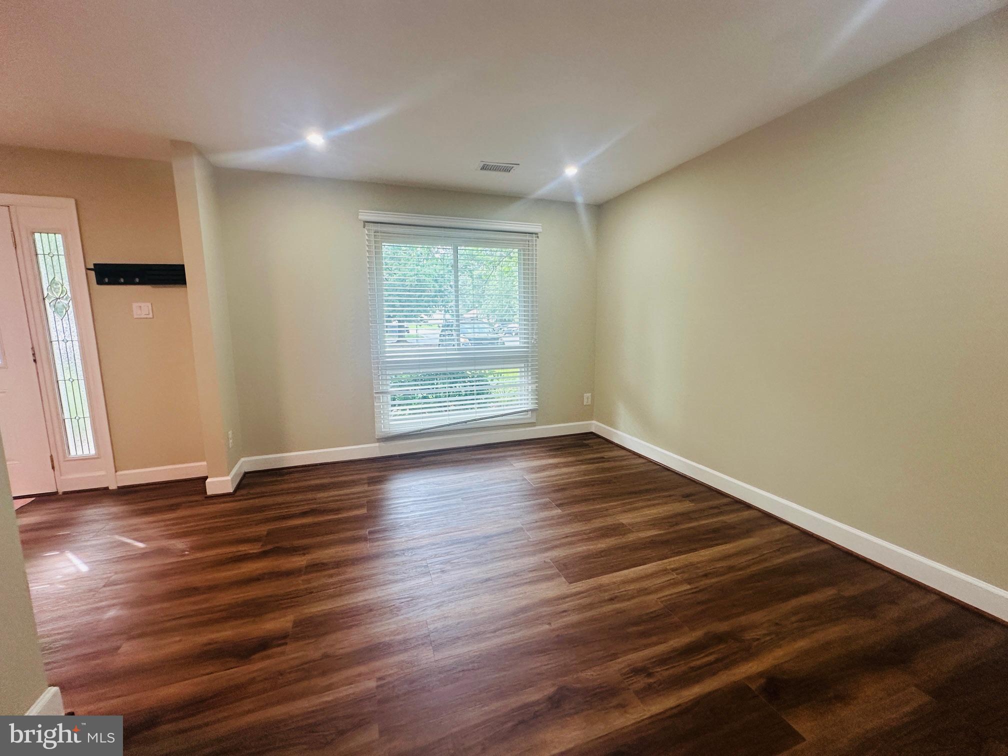 102 Hayloft Circle Sterling, VA 20164 - Photo 5 of 39 wooden floor in an empty room with a window