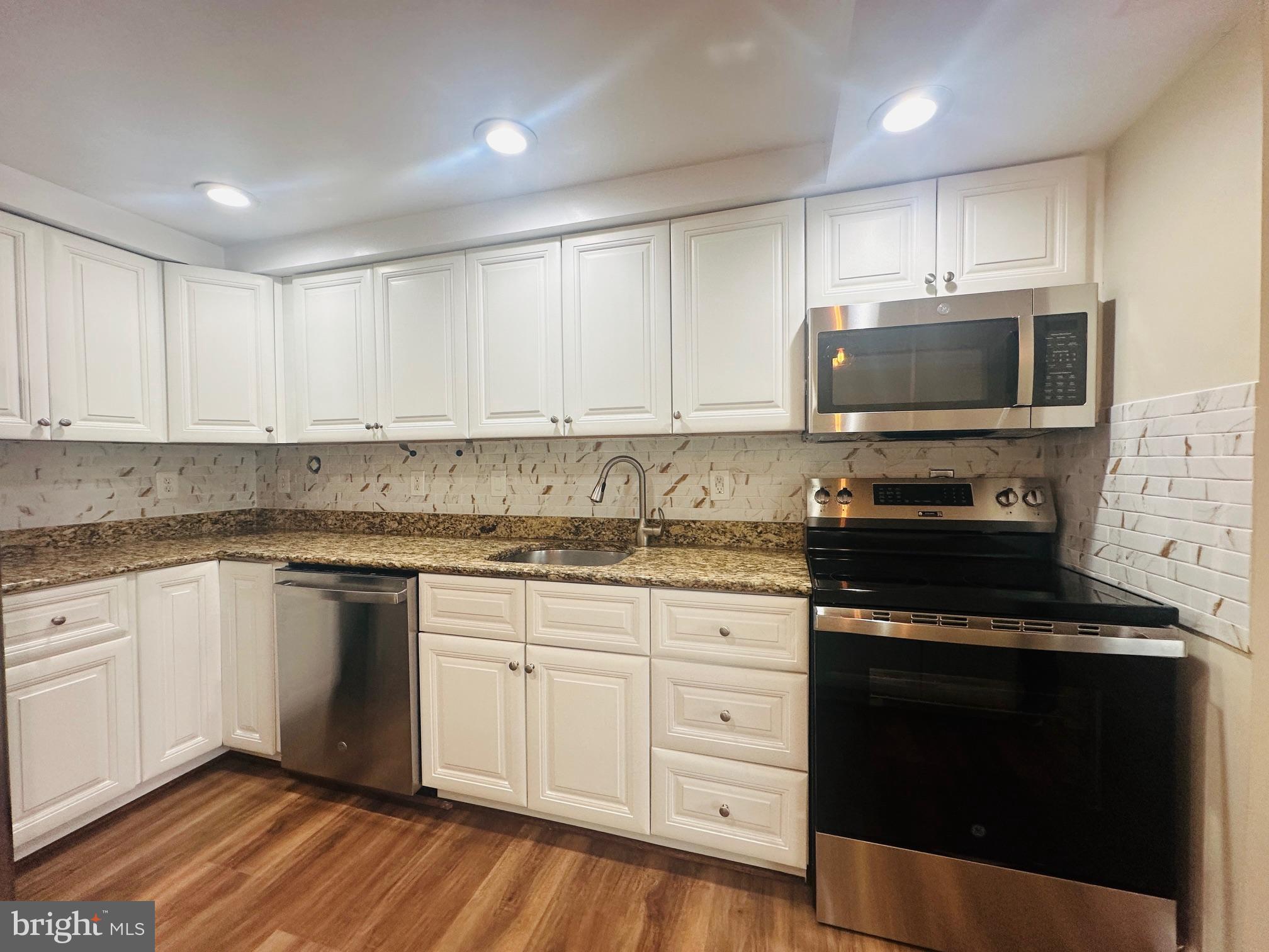 102 Hayloft Circle Sterling, VA 20164 - Photo 9 of 39 a kitchen with granite countertop a stove and a sink