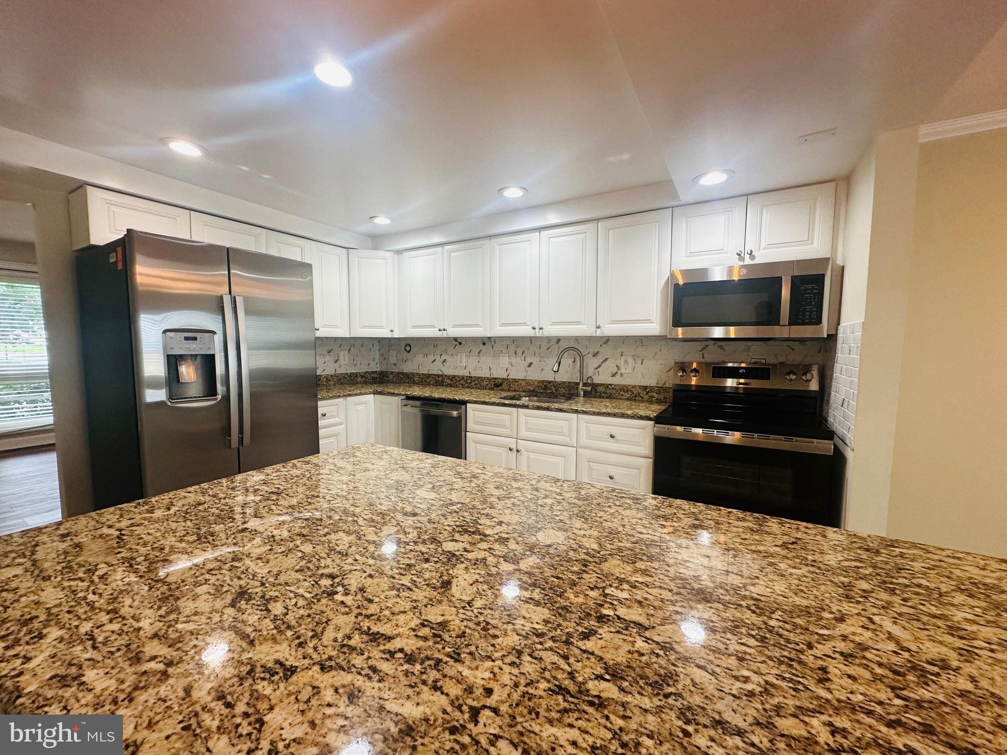 102 Hayloft Circle Sterling, VA 20164 - Photo 10 of 39 a kitchen with granite countertop a refrigerator stove and oven