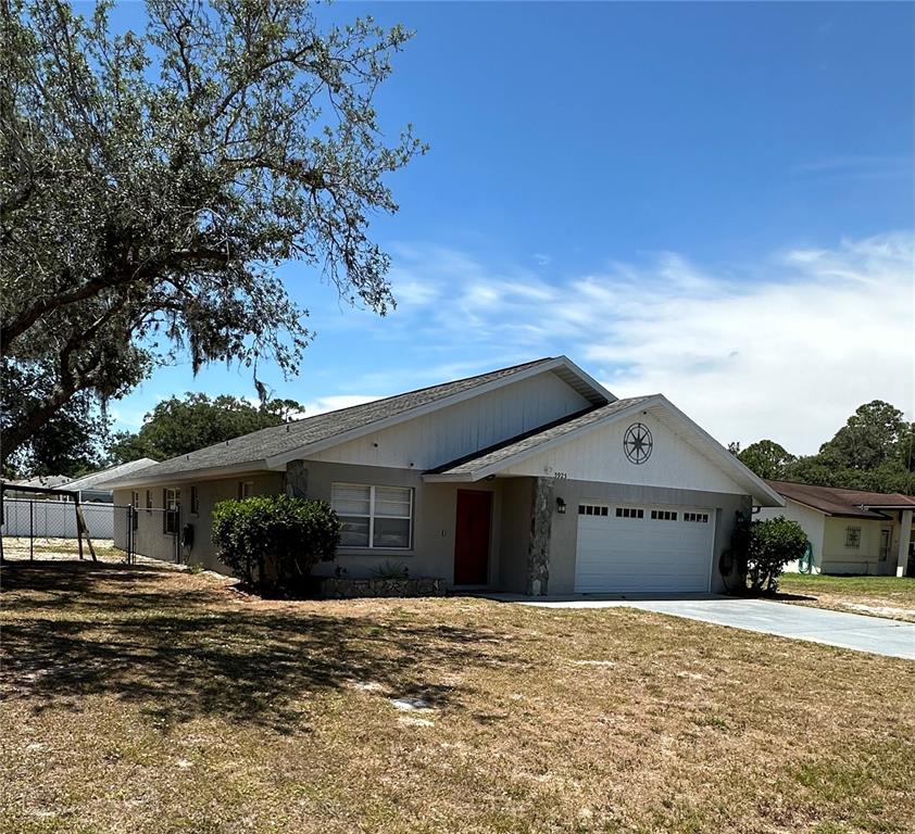 3923 Leaf Road Sebring, FL 33875 - Photo 1 of 1 a front view of a house with a yard and garage