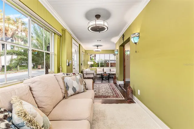 a living room with furniture a flat screen tv and a window