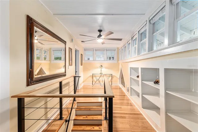 an aerial view of a house with a yard and lake view