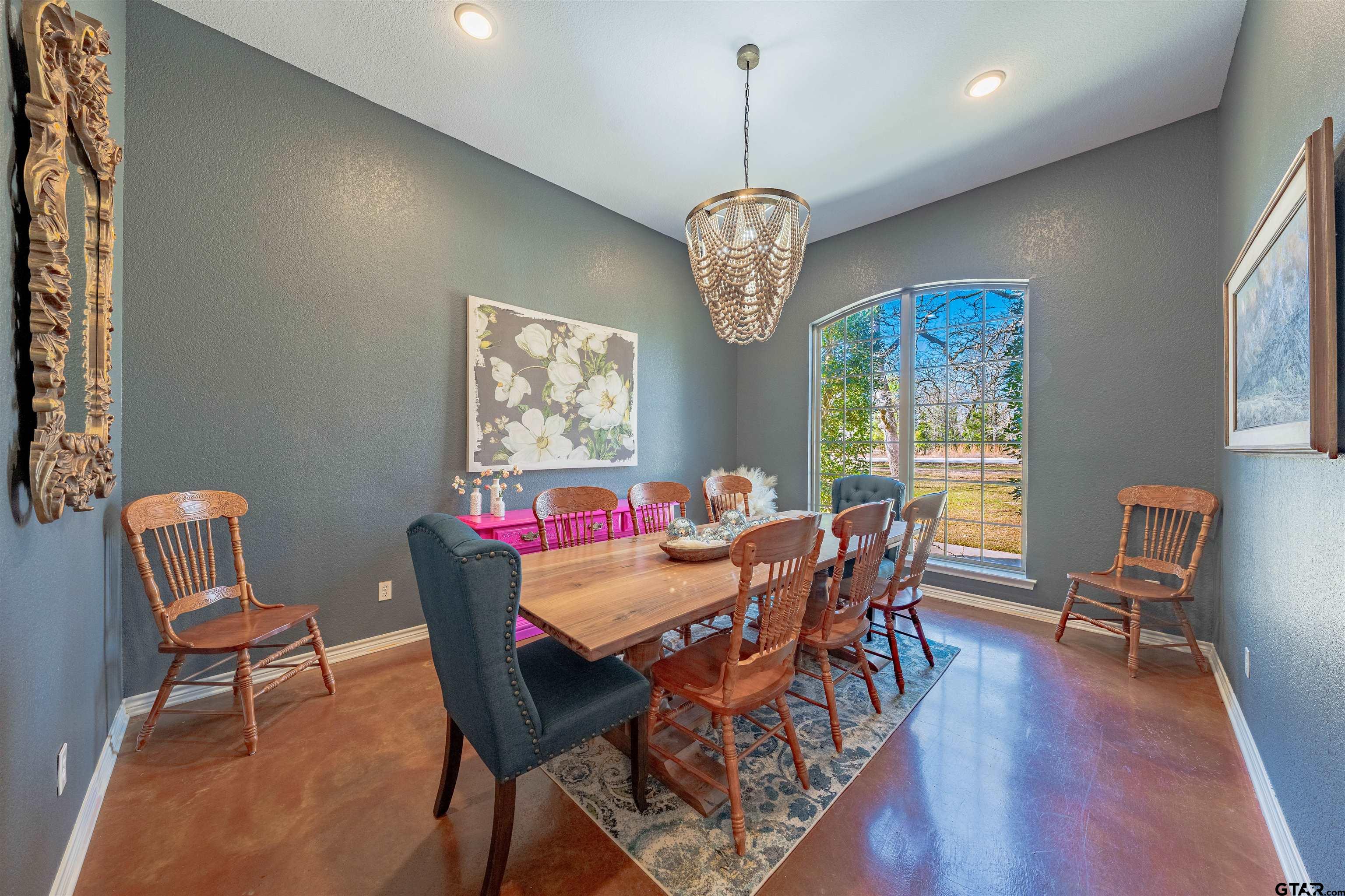 3597 Pedernales North Athens, TX 75752 - Photo 11 of 32 a view of a dining room with furniture a chandelier and wooden floor