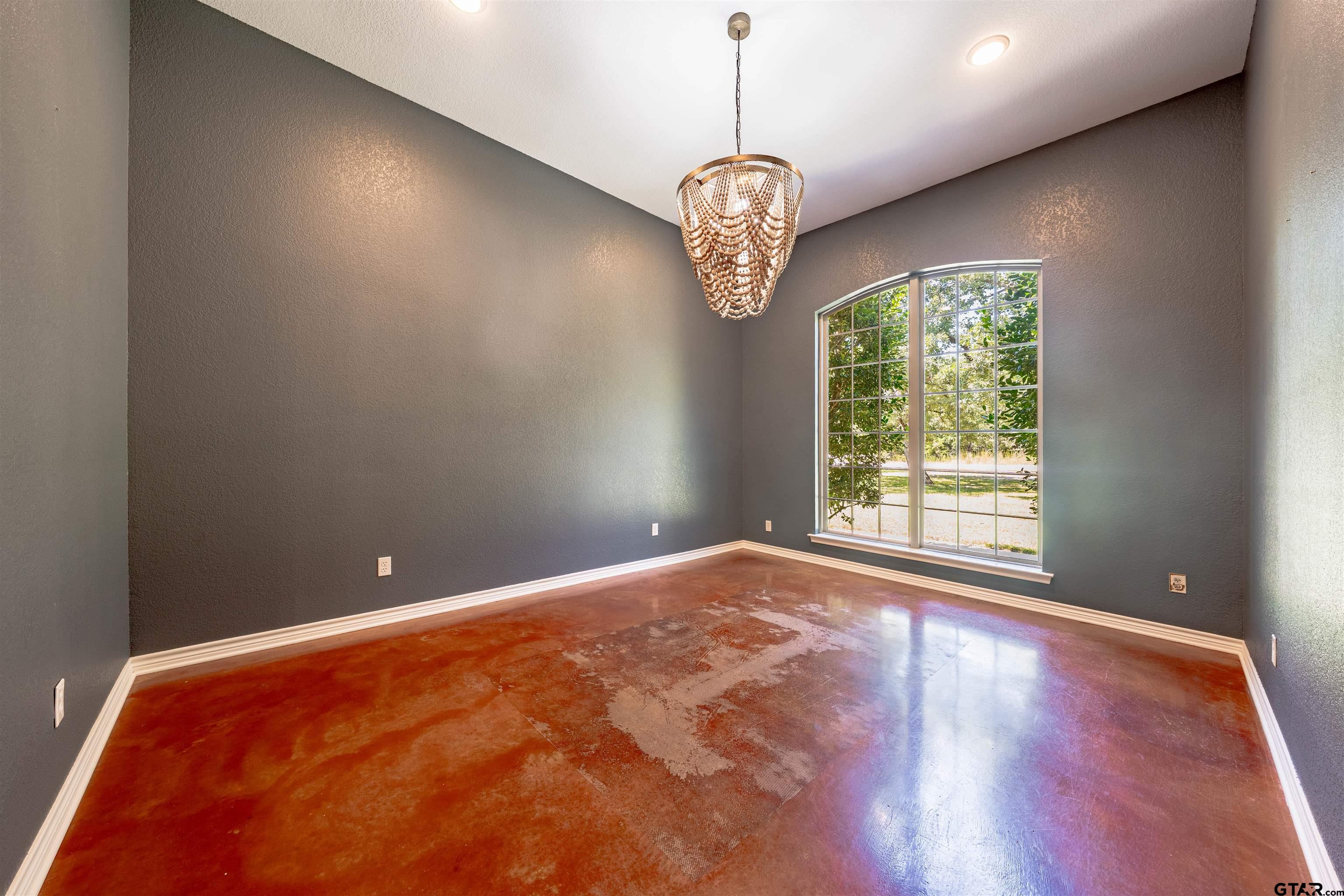 3597 Pedernales North Athens, TX 75752 - Photo 12 of 32 a view of an empty room with a window and chandelier