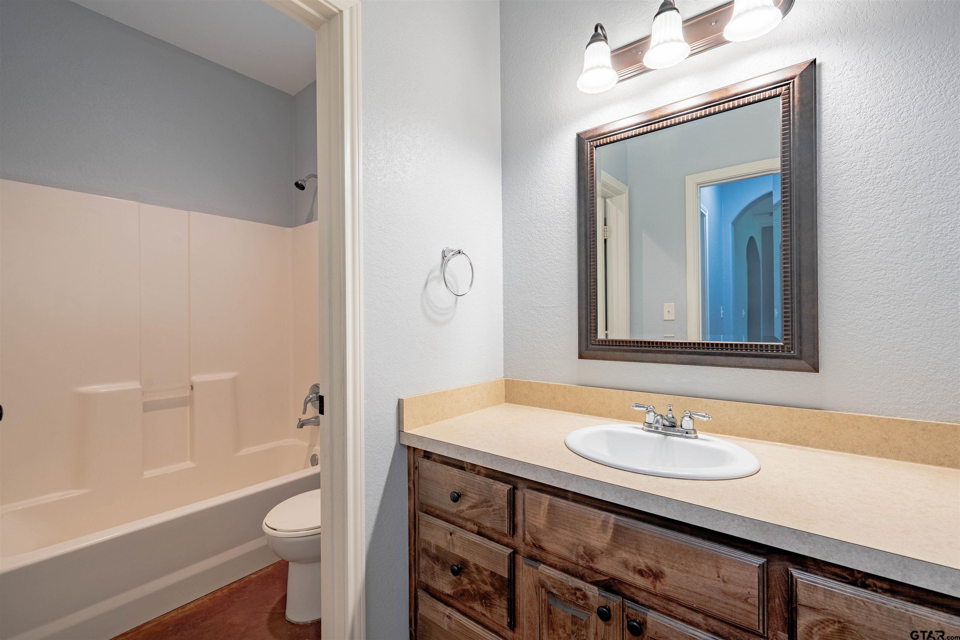 3597 Pedernales North Athens, TX 75752 - Photo 20 of 32 a bathroom with a sink a toilet a mirror and shower