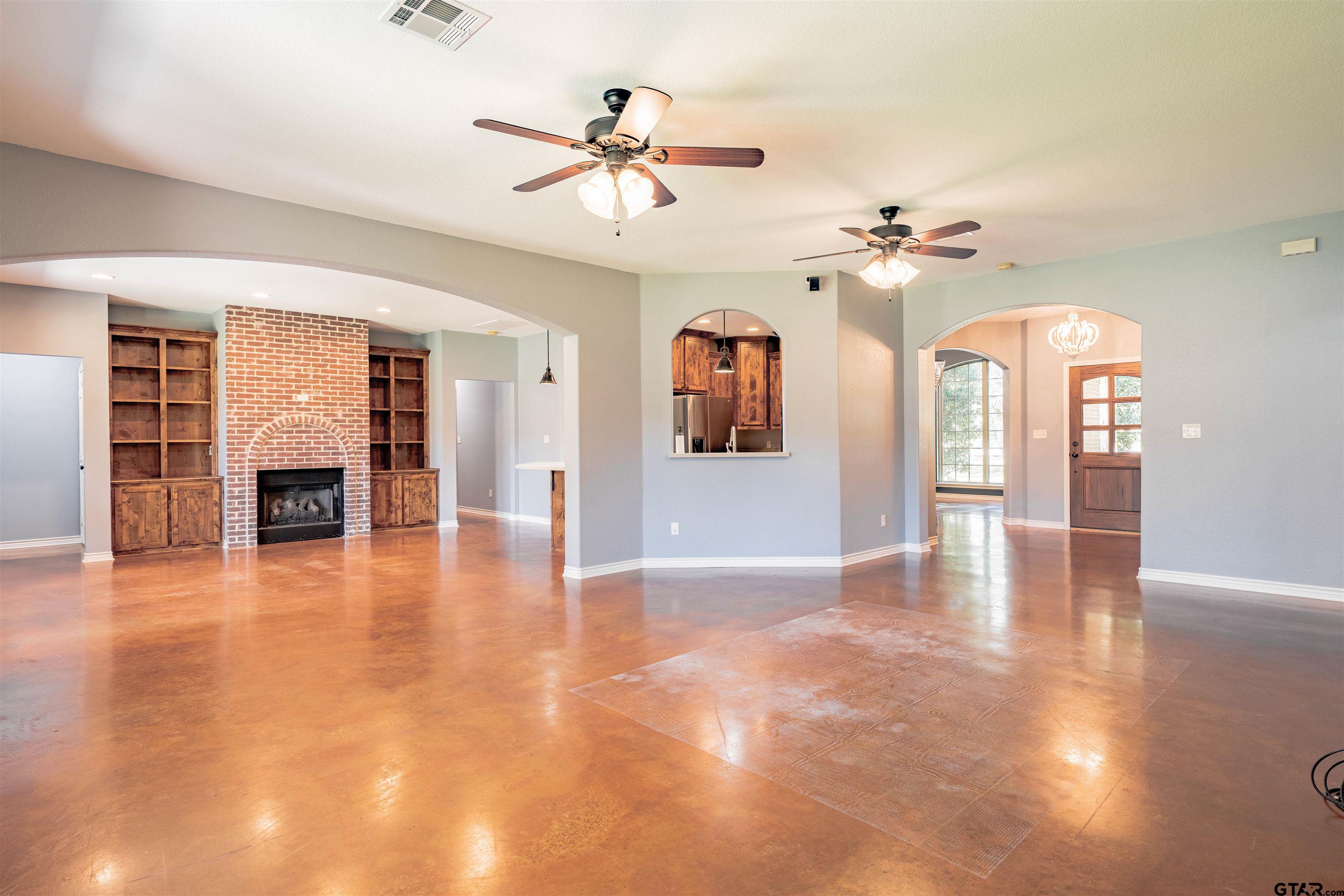 3597 Pedernales North Athens, TX 75752 - Photo 2 of 32 a view of an empty room with a fireplace and wooden floor