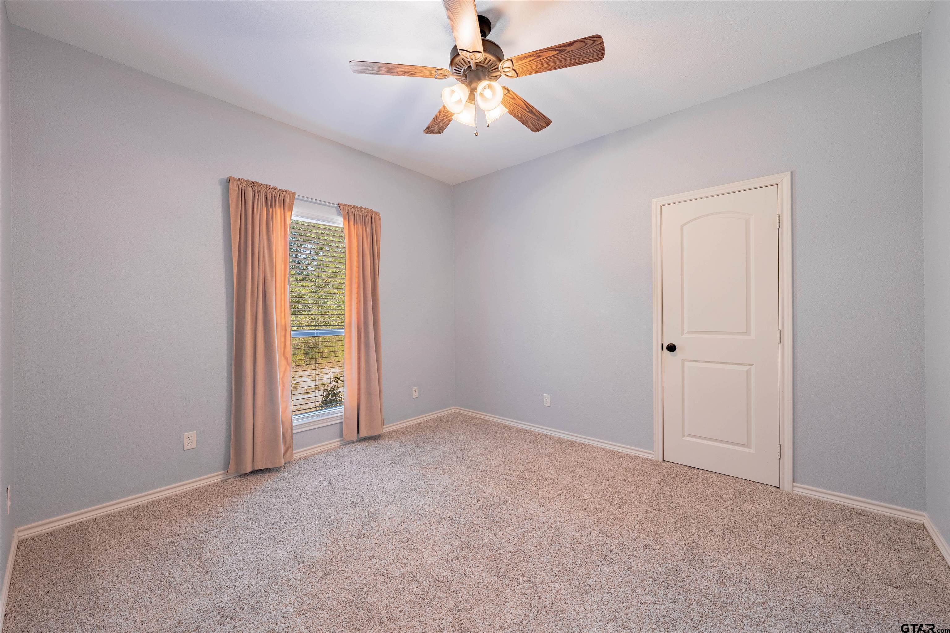 3597 Pedernales North Athens, TX 75752 - Photo 21 of 32 an empty room with windows and fan