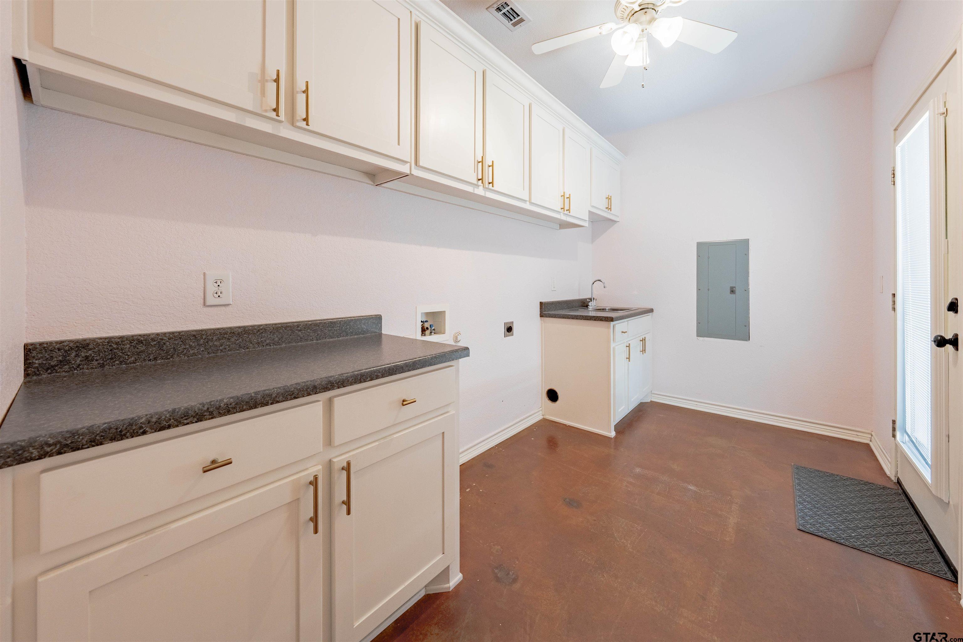 3597 Pedernales North Athens, TX 75752 - Photo 22 of 32 a kitchen with stainless steel appliances granite countertop a sink dishwasher and white cabinets with wooden floor