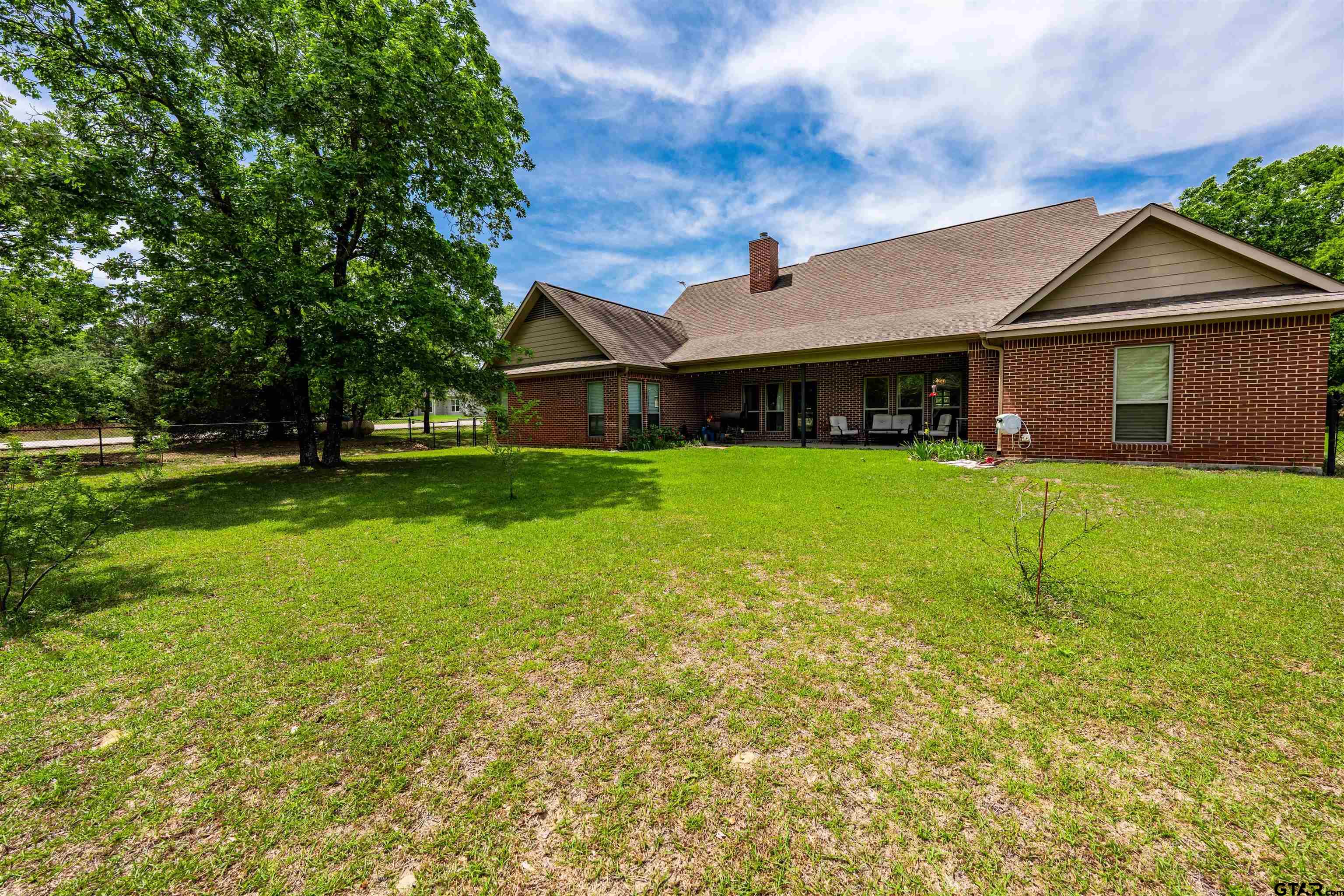 3597 Pedernales North Athens, TX 75752 - Photo 23 of 32 a view of a house with a big yard and potted plants