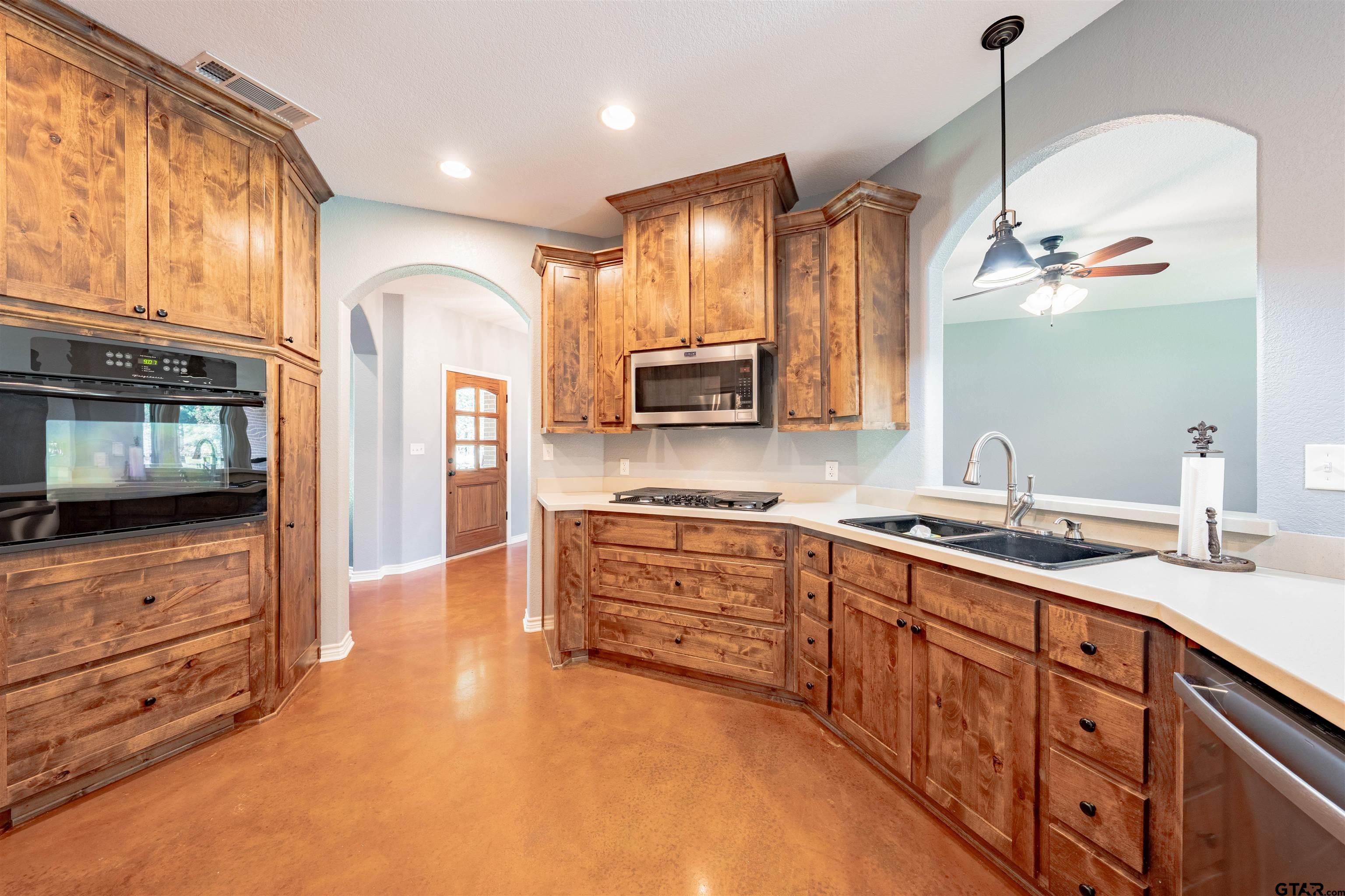 3597 Pedernales North Athens, TX 75752 - Photo 5 of 32 a kitchen with stainless steel appliances granite countertop a sink and stove top oven
