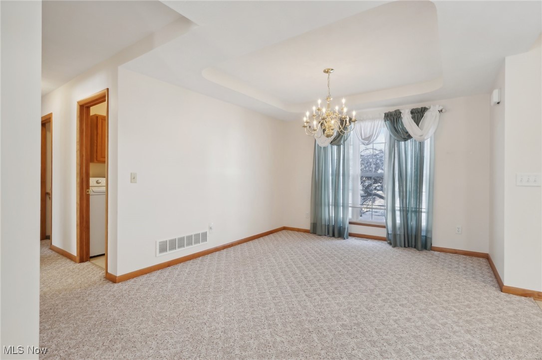 15139 Timber Ridge Drive Middlefield, OH 44062 - Photo 19 of 44 Formal Dining Room with Tray Ceiling and Chandelier