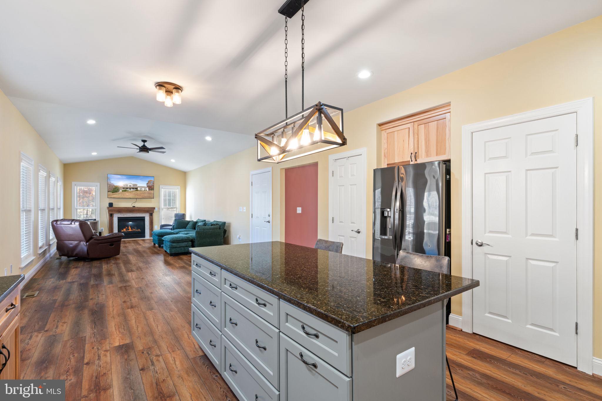 2182 Towles Road Midland, VA 22728 - Photo 17 of 50 a kitchen with stainless steel appliances granite countertop a stove refrigerator and couches