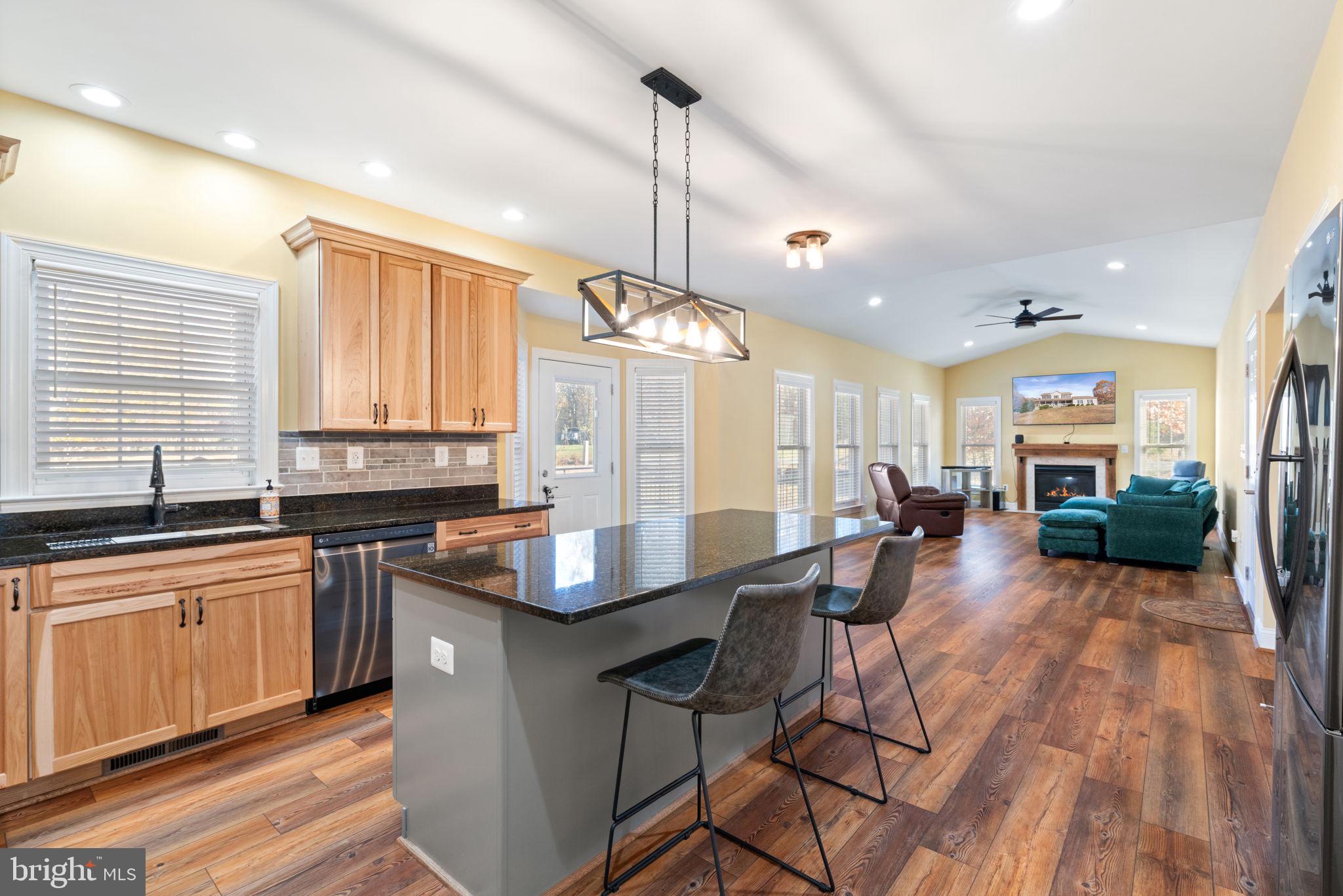 2182 Towles Road Midland, VA 22728 - Photo 19 of 50 a kitchen with stainless steel appliances granite countertop wooden cabinets a dining table and chairs