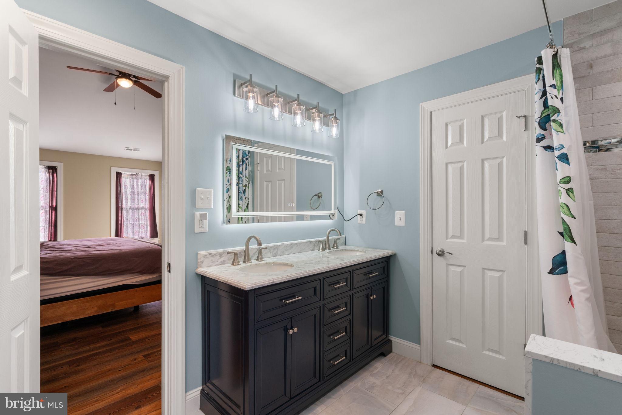 2182 Towles Road Midland, VA 22728 - Photo 30 of 50 a bathroom with a double vanity sink and a mirror