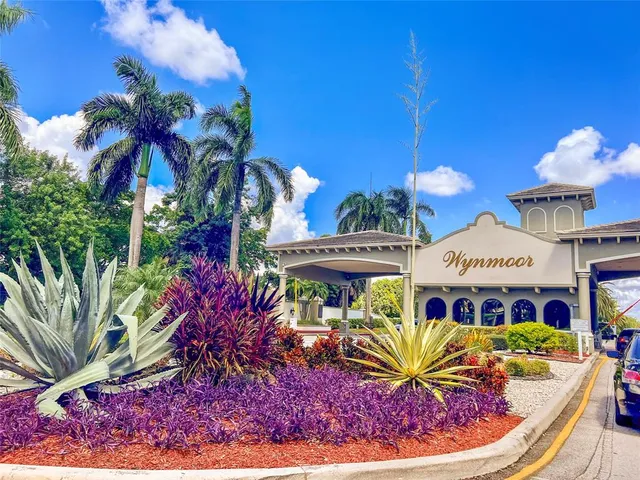 a view of a house with a fountain in front of it