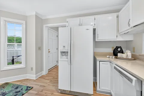 a kitchen with a refrigerator sink and cabinets