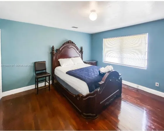 a spacious bedroom with a bed and a window