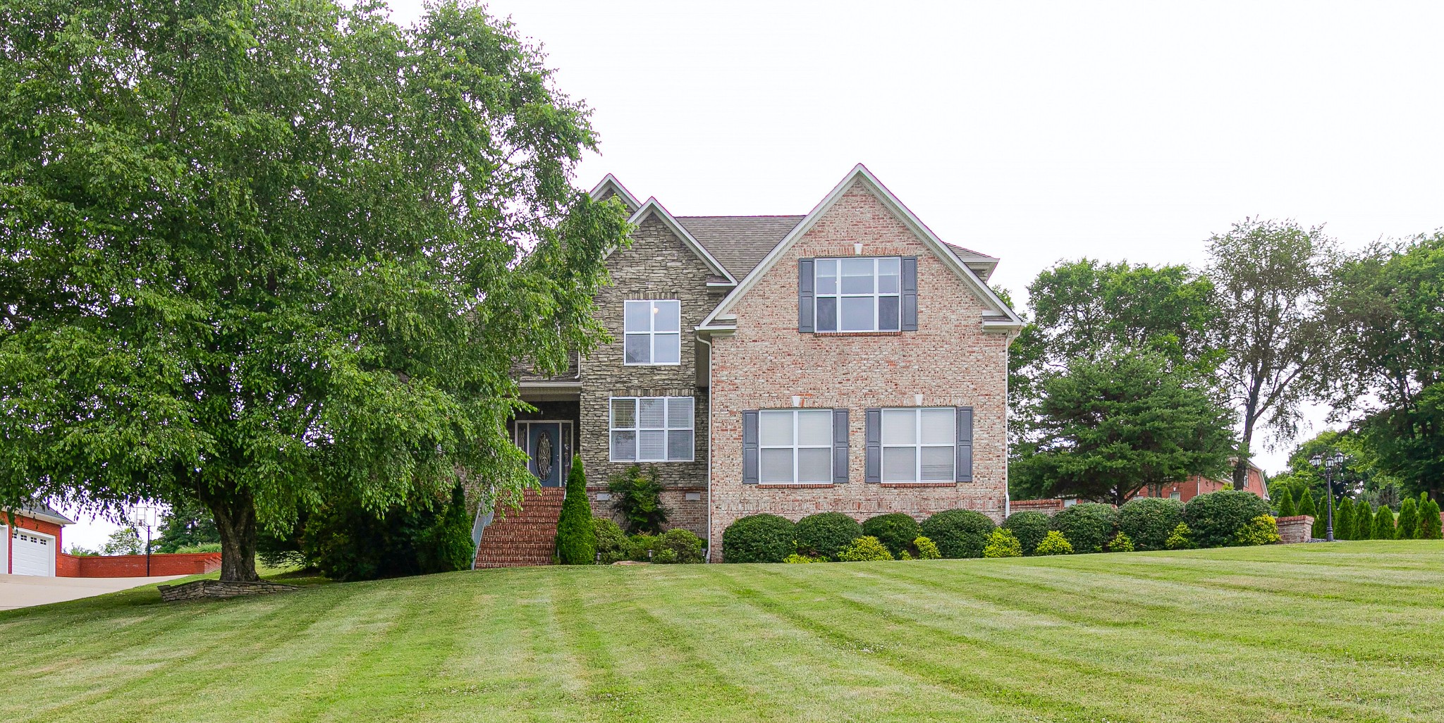3013 Viewpointe Way Columbia, TN 38401 - Photo 1 of 39 a view of a brick house next to a yard with big trees